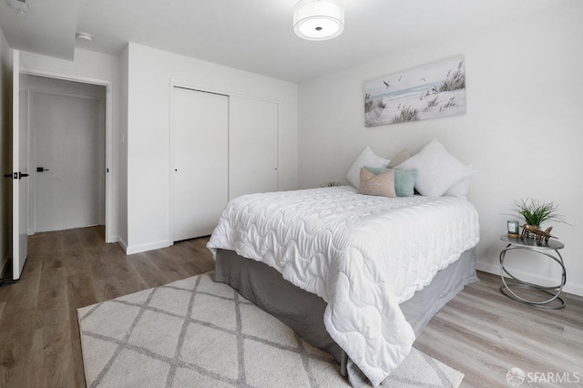 bedroom with a closet and hardwood / wood-style floors