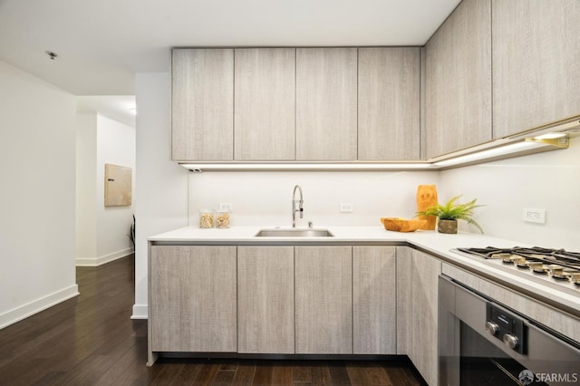 kitchen with wall oven, dark hardwood / wood-style flooring, stainless steel gas cooktop, and sink