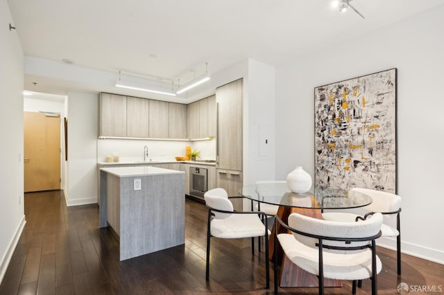 kitchen with dark wood-type flooring, sink, light brown cabinets, and a kitchen island