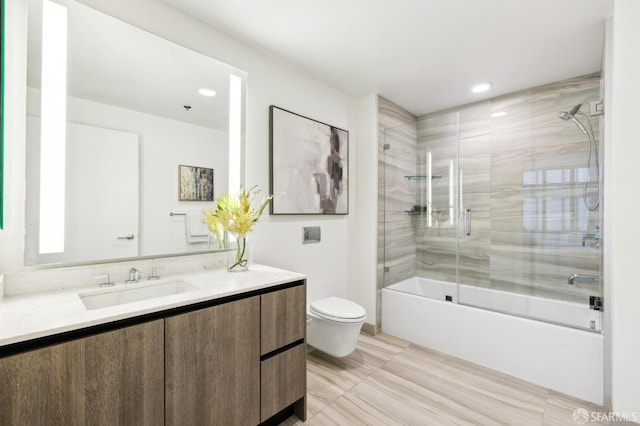 full bathroom with bath / shower combo with glass door, toilet, and vanity