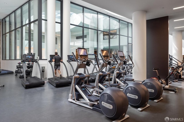 gym with a wall of windows and a high ceiling