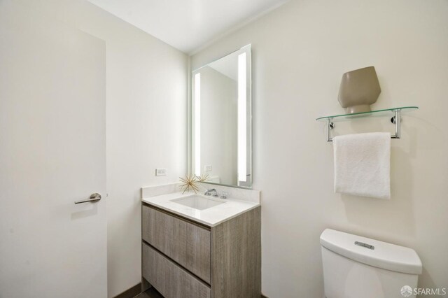 bathroom featuring toilet and vanity