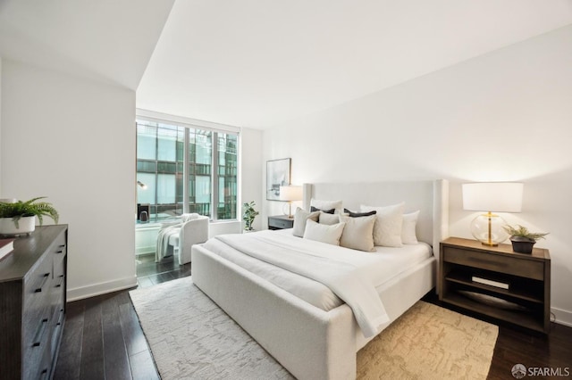 bedroom featuring hardwood / wood-style floors and expansive windows