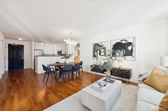 living room with wood finished floors and a chandelier