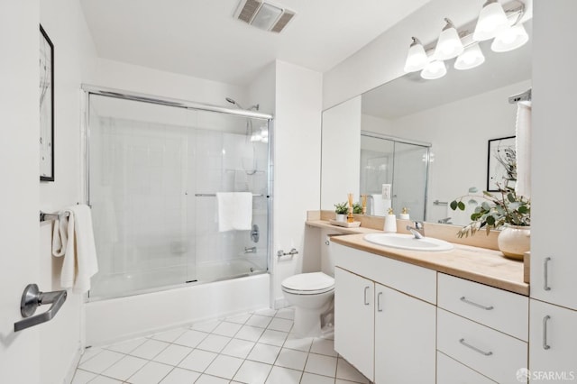 full bathroom featuring vanity, visible vents, bath / shower combo with glass door, tile patterned floors, and toilet