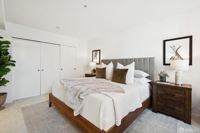 carpeted bedroom with a closet