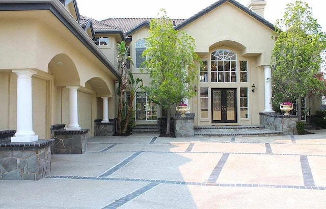 2220 Sunset Pt, Discovery Bay, CA 94505 - property entrance featuring french doors, stucco siding, and a chimney