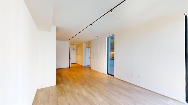 empty room with light hardwood / wood-style flooring