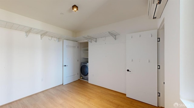 interior space with washer / dryer, a closet, and wood-type flooring