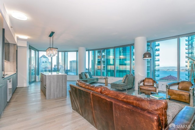 living room featuring an inviting chandelier and light hardwood / wood-style flooring