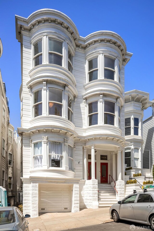2438 Clay St, San Francisco, CA 94115 - view of front of property with a garage, concrete driveway, and stone siding