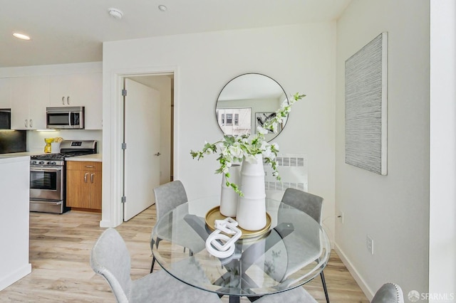 dining space with light wood-type flooring