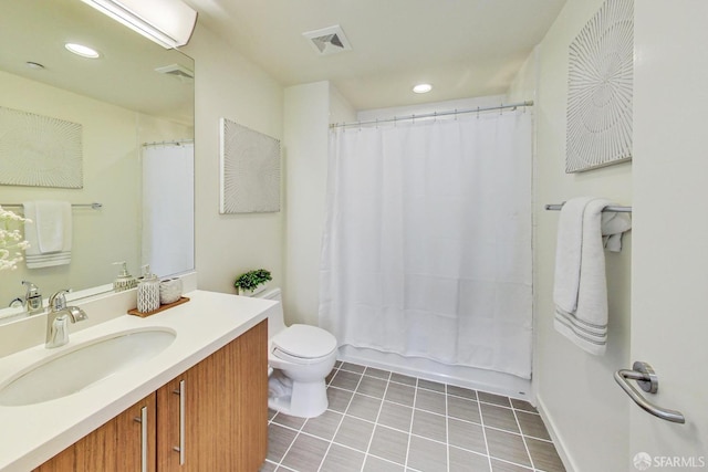 full bathroom featuring vanity, toilet, tile patterned flooring, and shower / bath combo with shower curtain