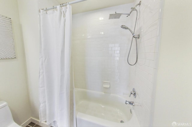 bathroom featuring toilet and shower / bath combo