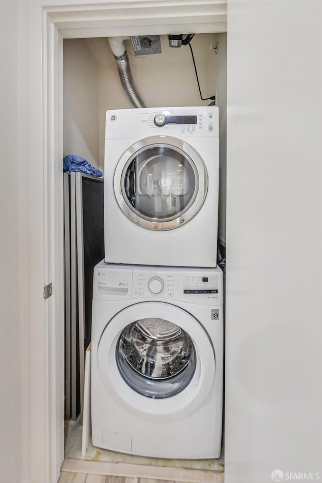 washroom with stacked washer / drying machine