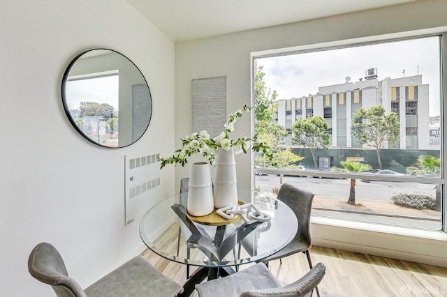 dining space featuring radiator and light hardwood / wood-style floors