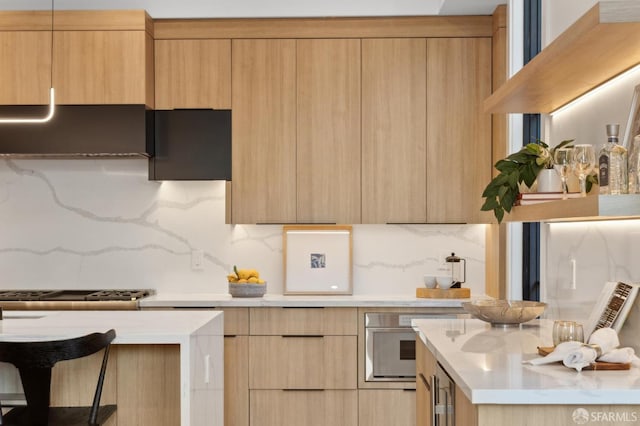 kitchen featuring oven, light brown cabinets, and modern cabinets