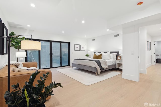 bedroom with baseboards, recessed lighting, visible vents, and light wood-style floors