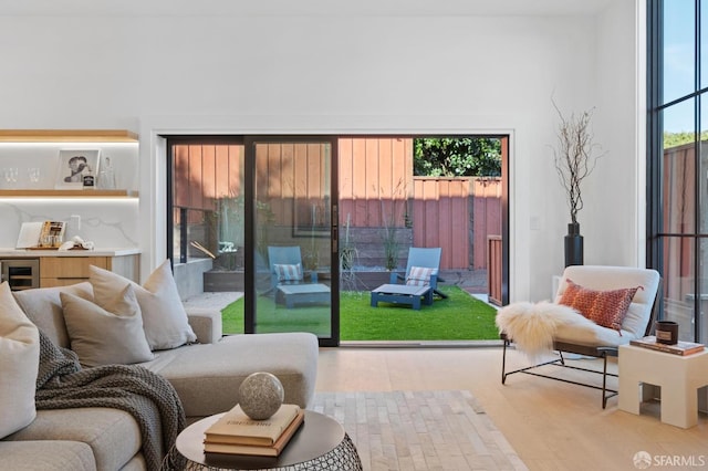 interior space with beverage cooler and wood finished floors