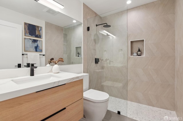 full bathroom featuring visible vents, vanity, toilet, and walk in shower