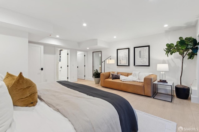 bedroom with light wood finished floors and recessed lighting