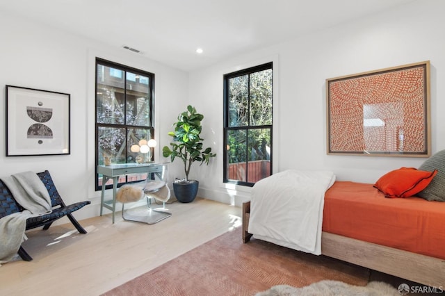 bedroom featuring wood finished floors, visible vents, and recessed lighting