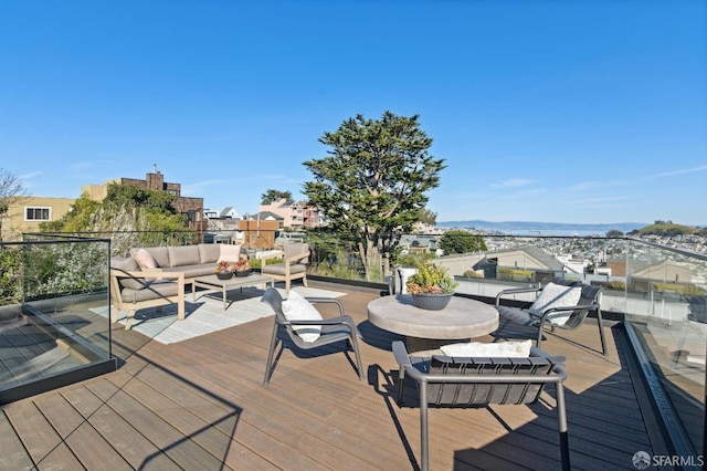 wooden terrace with a residential view and an outdoor hangout area