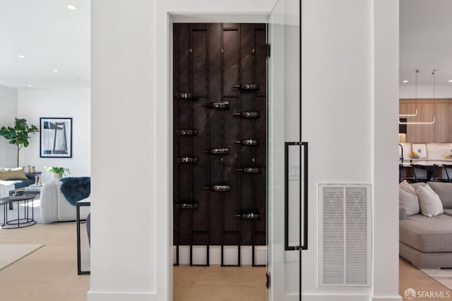 wine cellar featuring light wood-type flooring, visible vents, and recessed lighting