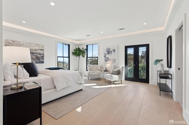 bedroom featuring light wood-style floors, multiple windows, visible vents, and french doors