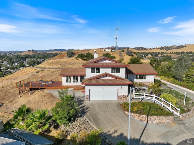 view of front of home featuring a mountain view and a garage