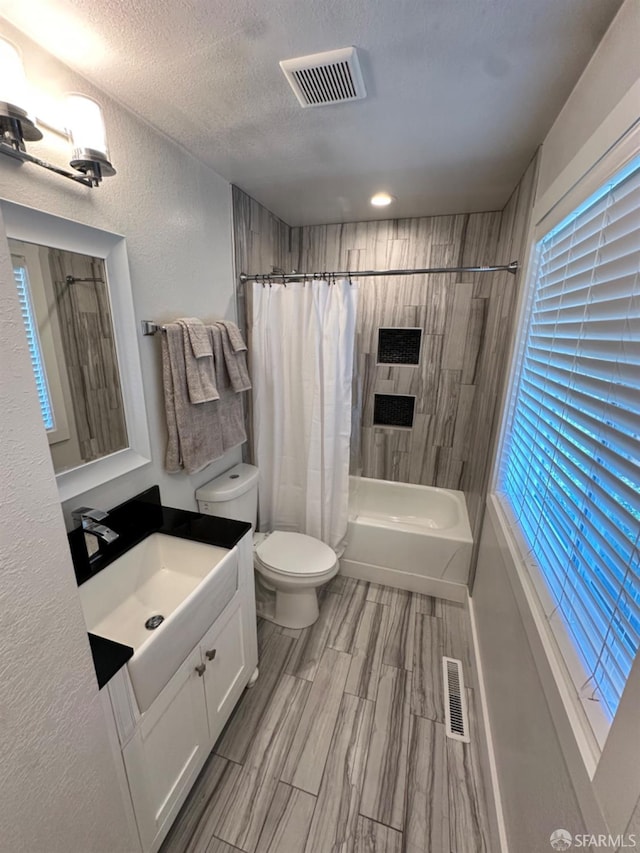 139 Hall Ln, Walnut Creek, CA 94597 - bathroom featuring shower / bath combination with curtain, toilet, vanity, and a textured ceiling
