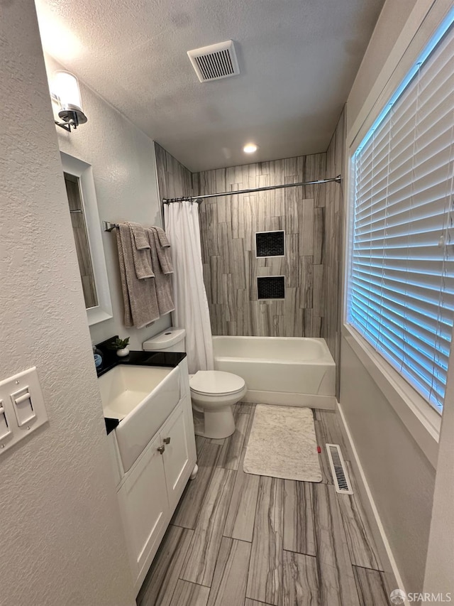 139 Hall Ln, Walnut Creek, CA 94597 - bathroom featuring shower / bath combo, vanity, a textured wall, and a textured ceiling