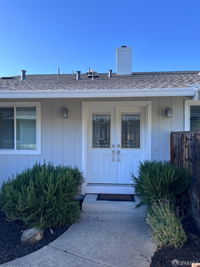 139 Hall Ln, Walnut Creek, CA 94597 - doorway to property with board and batten siding, a chimney, roof with shingles, and fence
