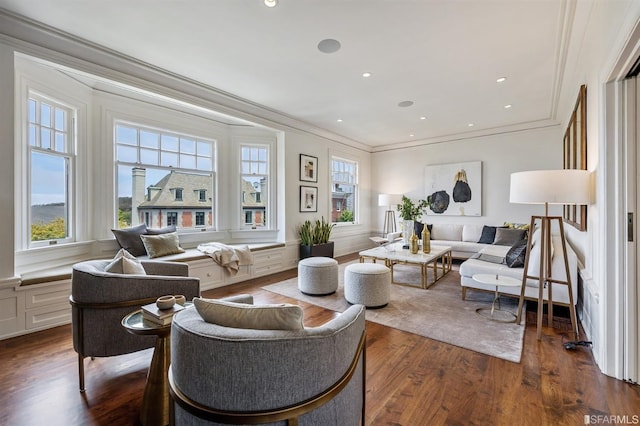 living room with dark hardwood / wood-style flooring and ornamental molding