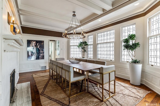 dining space featuring a notable chandelier, crown molding, dark wood-type flooring, and beamed ceiling