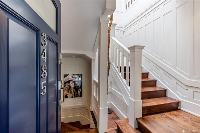 stairway with hardwood / wood-style floors