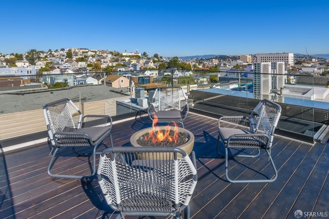 wooden deck featuring an outdoor fire pit