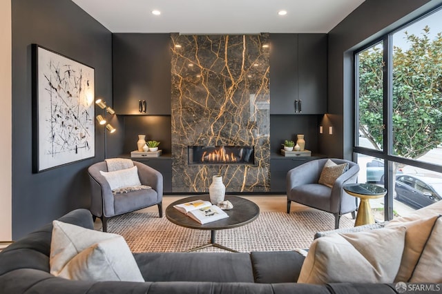 interior space with a fireplace, wood finished floors, and recessed lighting