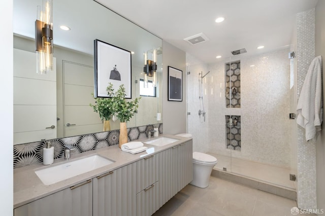 full bath with toilet, a stall shower, double vanity, and a sink