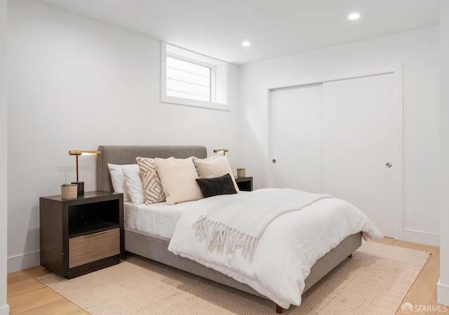 bedroom with wood-type flooring and a closet