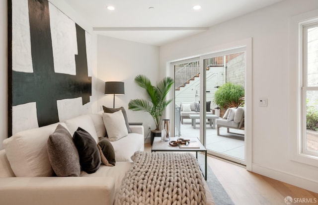 living area featuring plenty of natural light and light hardwood / wood-style floors