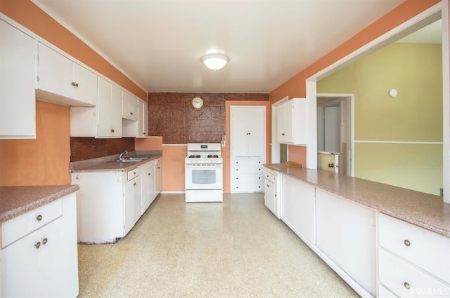 2567 Bryant St, San Francisco, CA 94110 - kitchen with white gas range, white cabinets, decorative backsplash, light floors, and light countertops