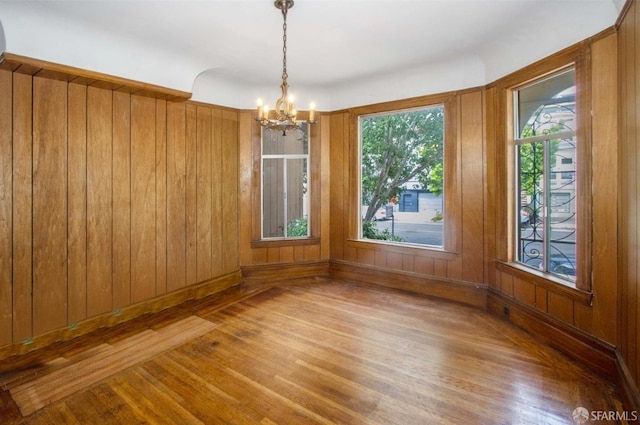 2567 Bryant St, San Francisco, CA 94110 - unfurnished room featuring a chandelier, wood finished floors, and wood walls