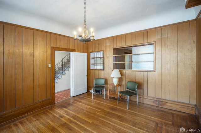 2567 Bryant St, San Francisco, CA 94110 - sitting room featuring wood finished floors, a chandelier, stairs, and wooden walls