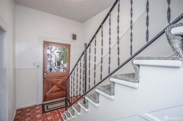 2567 Bryant St, San Francisco, CA 94110 - foyer featuring stairway and a textured ceiling