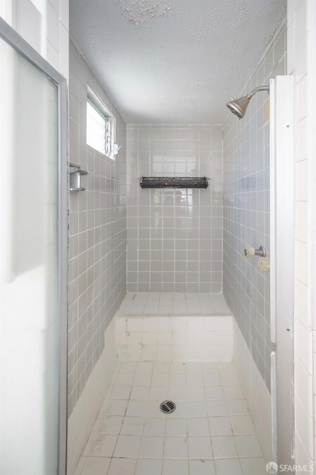 2567 Bryant St, San Francisco, CA 94110 - bathroom with a shower stall, tile patterned floors, and a textured ceiling