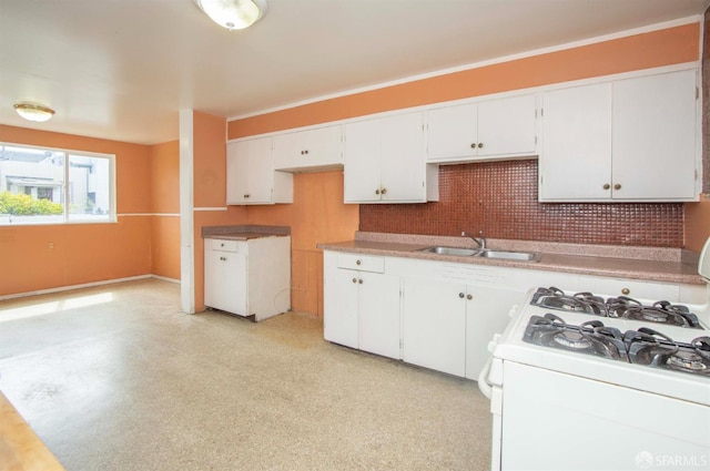 2567 Bryant St, San Francisco, CA 94110 - kitchen with white range with gas stovetop, decorative backsplash, white cabinets, light flooring, and crown molding