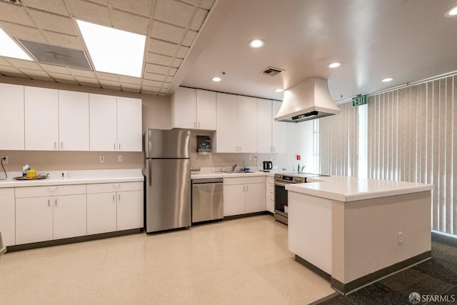 kitchen featuring visible vents, island range hood, stainless steel appliances, light countertops, and white cabinetry