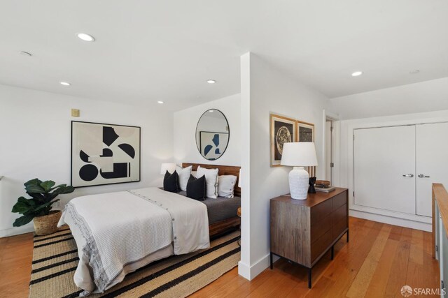 bedroom with light wood-style flooring, recessed lighting, and baseboards