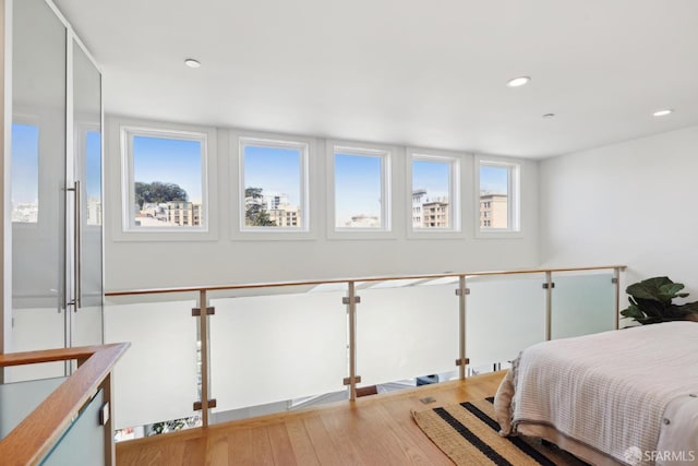 bedroom with wood finished floors and recessed lighting